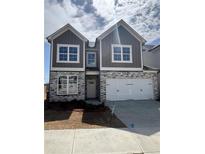 Charming two-story home featuring stone accents and a two-car garage at 274 Lakeside Place, Canton, GA 30114