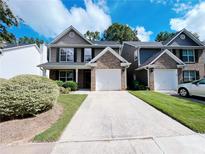 Charming two-story home features a brick-accented facade and attached one car garage at 1421 Gates Se Cir, Atlanta, GA 30316