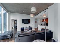 Relax in this stylish living room featuring modern lighting and an entertainment center at 400 W Peachtree Nw St # 2604, Atlanta, GA 30308