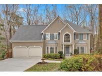 Charming home featuring a two-car garage, well-maintained landscaping, and beautiful architectural details at 931 Cornwall Sw Ct, Marietta, GA 30064