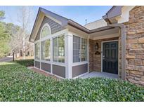 Charming sunroom entrance to a stone-accented home, featuring a black front door with the address displayed at 341 Ridge Hill Cir # 4, Marietta, GA 30064
