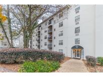 Apartment building exterior with well-maintained landscaping and covered entrance at 970 Sidney Marcus Blvd # 1217, Atlanta, GA 30324