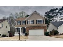 Charming two-story home featuring a brick and siding exterior, complemented by a well-maintained front yard and two-car garage at 634 Sandpiper Cv, Stockbridge, GA 30281