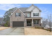Charming two-story home with a brick facade, dark shutters, and a well-maintained front yard and driveway at 3139 Hilltop Dr, Marietta, GA 30066