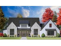 Beautiful two-story home featuring a brick and white-wood exterior, black-trimmed windows, and manicured landscaping at 1276 B Rutledge Rd, Acworth, GA 30101