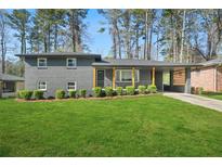 Charming gray brick home with manicured lawn and inviting curb appeal at 3048 San Jose Dr, Decatur, GA 30032