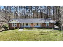 Charming single-story brick home with a well-manicured lawn and mature trees in a quiet neighborhood at 2415 Bankstone Sw Dr, Marietta, GA 30064