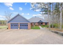 Charming brick home featuring an attached two-car garage and brick paver driveway at 5168 Parkview Rd, Social Circle, GA 30025