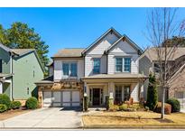 Charming two-story home with stone accents, a two-car garage, and a well-manicured lawn at 187 Still Pine Bnd, Smyrna, GA 30082