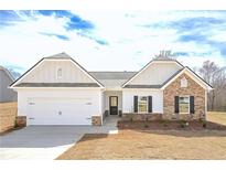 Charming single-Gathering home with stone accents, a two-car garage, and a well-maintained lawn at 475 Charleston Pl, Villa Rica, GA 30180