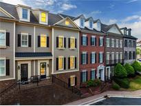 Charming townhomes boast a mix of brick and siding with well-manicured lawns and inviting entrances at 2130 Monhegan Se Way # 11, Smyrna, GA 30080