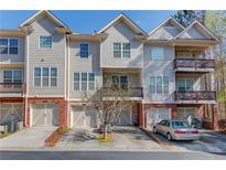 Charming townhome exterior featuring a private balcony, attached garage, and well-maintained landscaping at 2382 Gallard St, Lawrenceville, GA 30043