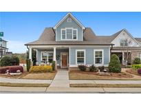Charming home with blue siding, a covered porch with seating, and well-maintained landscaping at 200 Oakside Way, Lawrenceville, GA 30046