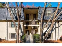 Charming condo with exterior balconies, black shutters, and well-maintained landscaping, a great place to call home at 112 Rosaire Nw Pl, Atlanta, GA 30327