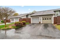 Charming townhome exterior with well-maintained garages and blossoming landscaping at 4974 Meadow Ln, Marietta, GA 30068