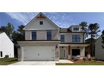 Charming two-story home featuring a brick facade, a two-car garage, and a covered front porch with wooden columns at 376 Waterbluff Dr, Mableton, GA 30126