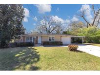 Charming single-story home with a well-maintained lawn and a convenient covered carport at 3811 Turner Heights Dr, Decatur, GA 30032