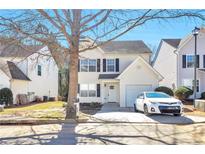 Charming two-story home with a well-maintained lawn and inviting curb appeal on a sunny day at 344 Springbottom Ct, Lawrenceville, GA 30046