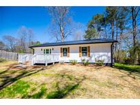 Charming home with white siding, shutters, and a lovely, inviting front porch at 116 Carroll St, Temple, GA 30179