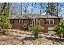 Charming brick ranch with mature trees, offering classic style and curb appeal at 2696 Dodson Dr, East Point, GA 30344