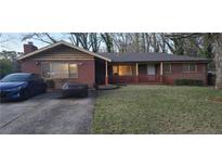 Charming single-story brick home with a cozy front porch and well-maintained lawn at 2572 Tyler Way, Decatur, GA 30032