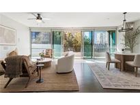 Bright living room boasts floor-to-ceiling windows, modern furnishings, and an open layout at 700 Park Regency Ne Pl # 803, Atlanta, GA 30326