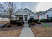 Charming single-story home with a welcoming front porch and well-maintained landscaping at 4531 Flowering Br, Powder Springs, GA 30127