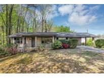 Charming brick ranch-style home with a carport and well-maintained landscaping at 9258 Westview Sw Dr, Covington, GA 30014