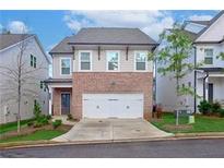 Charming two-story home featuring brick accents, a two-car garage, and a well-manicured lawn at 656 Avondale Park Cir, Decatur, GA 30032