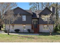 Charming two-story home with a combination of siding and painted brick exterior and inviting front entrance at 3427 Saddleton Way, Douglasville, GA 30134