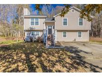 Charming two-story home with a well-maintained lawn and inviting front entrance at 1059 Buckboard Ct, Douglasville, GA 30134