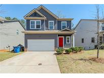 Charming two-story home with a gray facade, red front door, and attached two-car garage at 169 Parkview Place Dr, Mcdonough, GA 30253