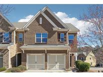 Charming two-story townhome with a two-car garage and brick facade at 5895 Sheppard Dr, Cumming, GA 30040