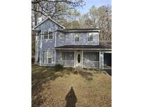 Charming two-story home with a welcoming covered front porch and a well-maintained yard at 851 Hedge Garden Ct, Stone Mountain, GA 30088