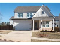 Charming two-story home featuring a white facade, attached garage, and a well-manicured front lawn at 290 Brighton Bend Ln, Acworth, GA 30102