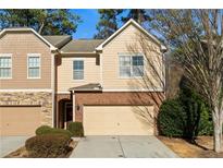 Charming two-story townhouse featuring a brick-and-siding facade and a two-car attached garage at 1570 Lenox Overlook Ne Rd, Atlanta, GA 30329