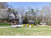 Charming two-story home with well-manicured lawn, mature trees and outbuildings at 158 Lambeth Dr, Hiram, GA 30141