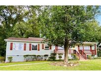Charming one-story home featuring light blue siding, red shutters, and a welcoming front porch at 2222 Beecher Sw Rd, Atlanta, GA 30311