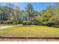 Charming single-story home features a well-manicured lawn and a welcoming walkway at 3645 Larkspur Ter, Decatur, GA 30032