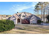 Inviting home features a manicured lawn, mature trees, and beautiful landscaping, providing excellent curb appeal at 2220 Emerald Dr, Jonesboro, GA 30236