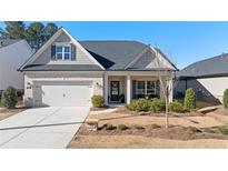 Charming single-Gathering home with a manicured lawn, brick accents, and a welcoming front porch at 130 Brayden Park Dr, Canton, GA 30115