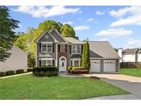 Charming two-story home with manicured lawn, attached garages, and welcoming curb appeal at 2360 Brookgreen Commons, Kennesaw, GA 30144