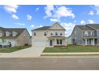 Charming two-story home with manicured lawn, attached garage, and welcoming blue front door at 537 Teversham Dr, Mcdonough, GA 30253