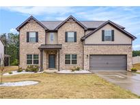 Charming brick two-story home featuring a two-car garage and well-maintained landscaping at 224 Osier Dr, Mcdonough, GA 30252