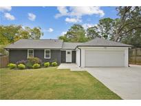 Charming single-story home featuring a well-manicured lawn, painted brick, and an attached two-car garage at 2041 Briarcliff Ne Rd, Atlanta, GA 30329