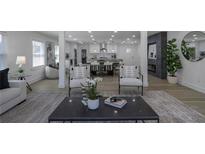 Spacious living room with hardwood floors, modern fireplace, and open floor plan to dining and kitchen at 2041 Briarcliff Ne Rd, Atlanta, GA 30329