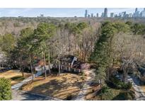 Charming two-story home with a manicured lawn and mature trees, offering both curb appeal and privacy at 725 Glengary Ne Way, Atlanta, GA 30342