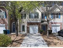 Charming townhome featuring a single-car garage and a well-maintained front yard at 5740 Terremont Cir, Norcross, GA 30093
