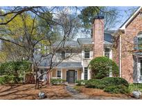 Charming two-story traditional home with brick accents, a well-manicured front yard, and a welcoming entrance at 165 River Ridge Ln, Roswell, GA 30075