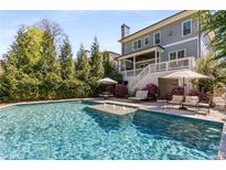 Beautiful backyard pool area, complete with lounging chairs and lush landscaping creating a private outdoor oasis at 2033 Lee Se Rd, Smyrna, GA 30080